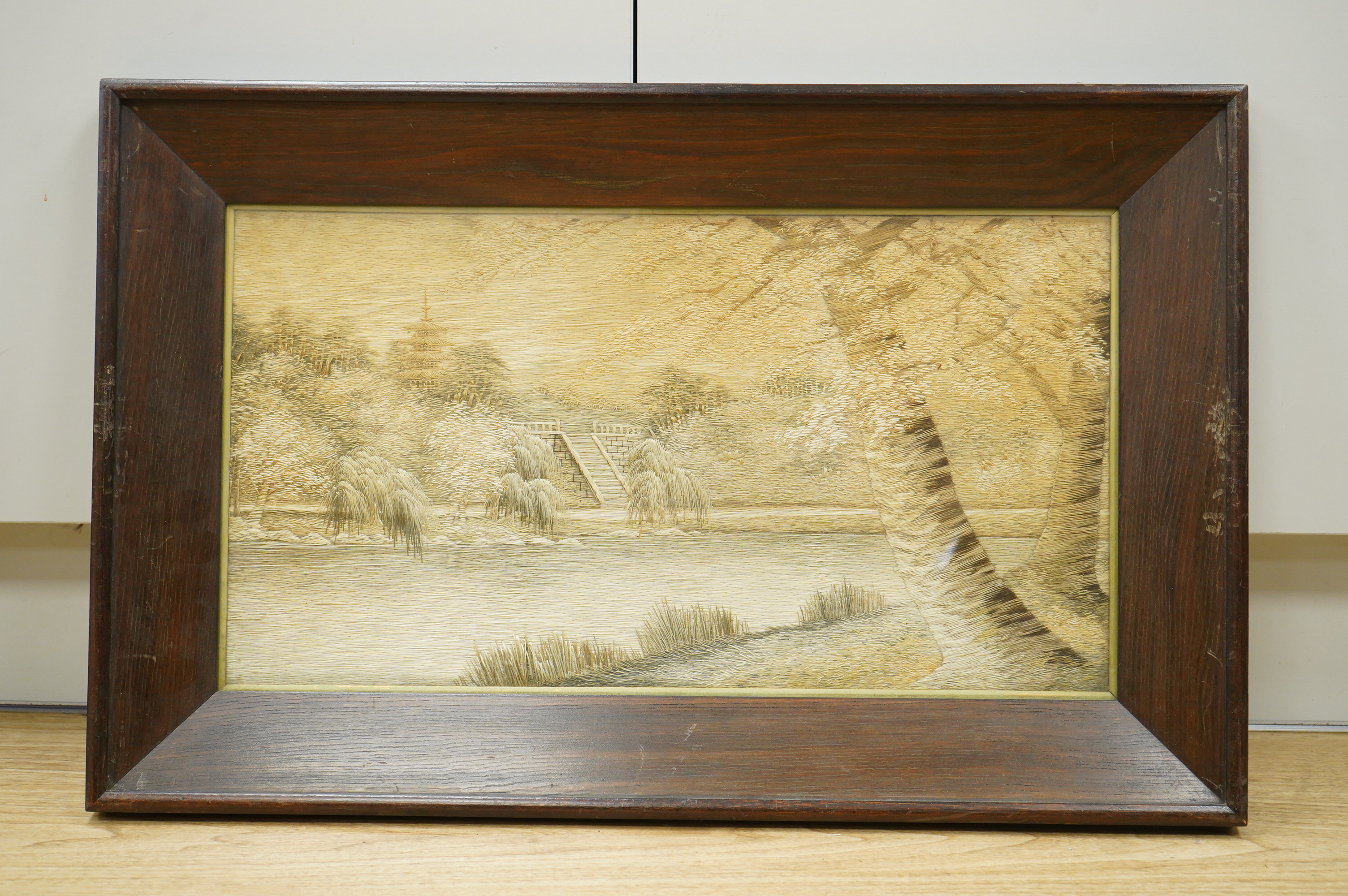 A pair of Japanese silk embroidered framed panels, 30 x 55cm